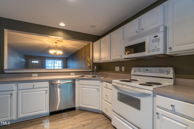 803 Creek Crossing Trl, Whitsett, NC 27377 - kitchen with white appliances, a chandelier, white cabinetry, light wood finished floors, and recessed lighting