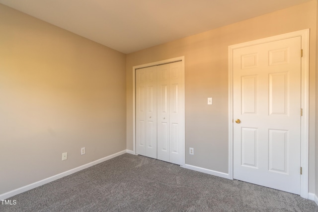 803 Creek Crossing Trl, Whitsett, NC 27377 - unfurnished bedroom featuring dark colored carpet and a closet