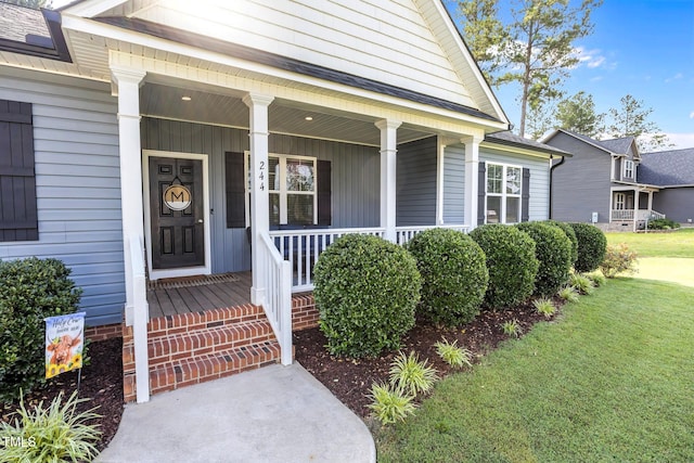 244 Lasswade Ct, Zebulon, NC 27597 - doorway to property featuring covered porch and a yard