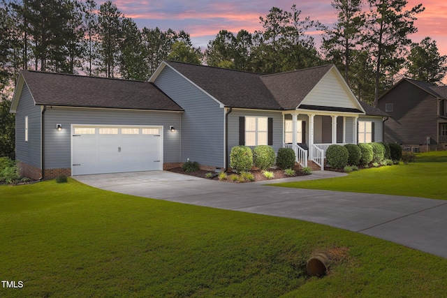 244 Lasswade Ct, Zebulon, NC 27597 - view of front of house with an attached garage, covered porch, concrete driveway, a yard, and a shingled roof