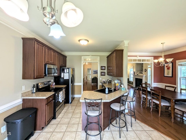 70 Dexterfield Dr, Fuquay Varina, NC 27526 - kitchen featuring stainless steel appliances, a chandelier, a breakfast bar area, light countertops, and ornamental molding