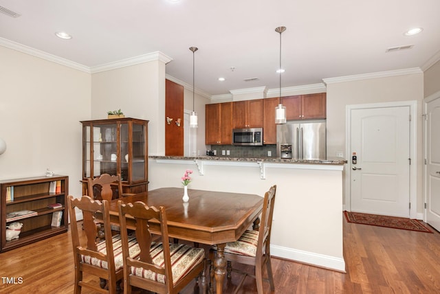 7250 NC-751 Hwy, Durham, NC 27707 - dining room with wood finished floors, recessed lighting, and crown molding