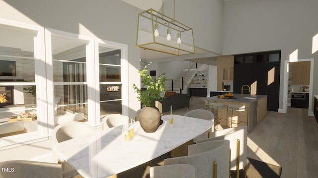 802 Warren Ave, Cary, NC 27511 - dining area featuring stairway, a towering ceiling, and light wood-type flooring