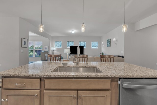 2626 Nassau Trce, Fuquay Varina, NC 27526 - kitchen with stainless steel dishwasher, open floor plan, light stone countertops, and pendant lighting