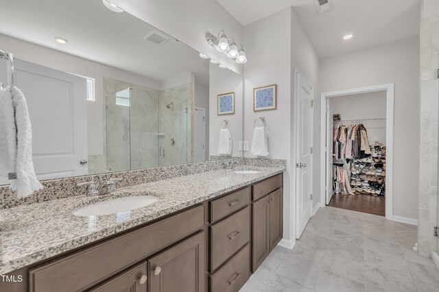 2626 Nassau Trce, Fuquay Varina, NC 27526 - bathroom featuring a shower stall, double vanity, a spacious closet, and recessed lighting