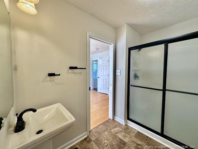162 E Twelve Oaks Rd, Raeford, NC 28376 - bathroom with a shower stall and a textured ceiling
