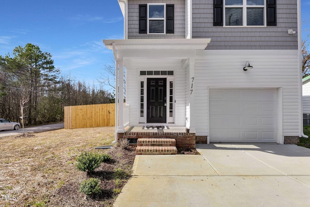 717 Utley St, Holly Springs, NC 27540 - property entrance with a garage and driveway