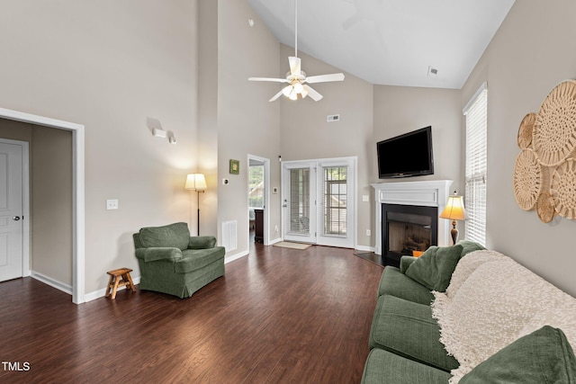 100 Tobacco Leaf Ln, Apex, NC 27502 - living room featuring wood finished floors, a fireplace, healthy amount of natural light, ceiling fan, and high vaulted ceiling