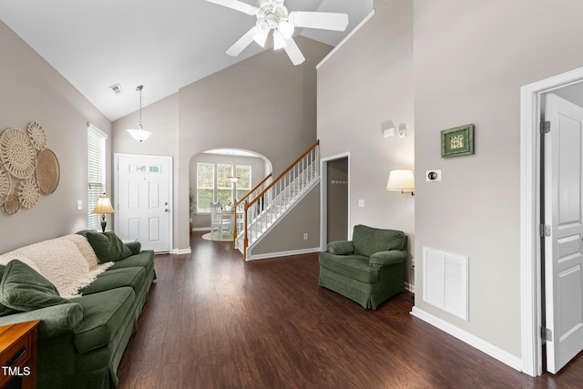 100 Tobacco Leaf Ln, Apex, NC 27502 - living area featuring high vaulted ceiling, stairs, ceiling fan, dark wood finished floors, and arched walkways