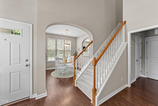 100 Tobacco Leaf Ln, Apex, NC 27502 - foyer entrance with arched walkways, dark wood-type flooring, stairway, and a towering ceiling