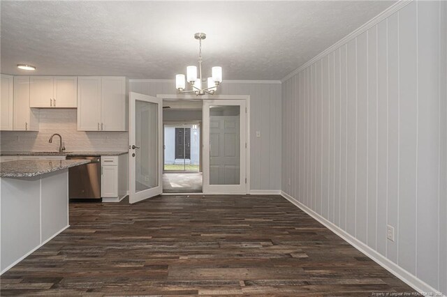 2110 Lombardy Dr, Fayetteville, NC 28304 - kitchen featuring dishwasher, a textured ceiling, a chandelier, dark wood-style flooring, and white cabinets