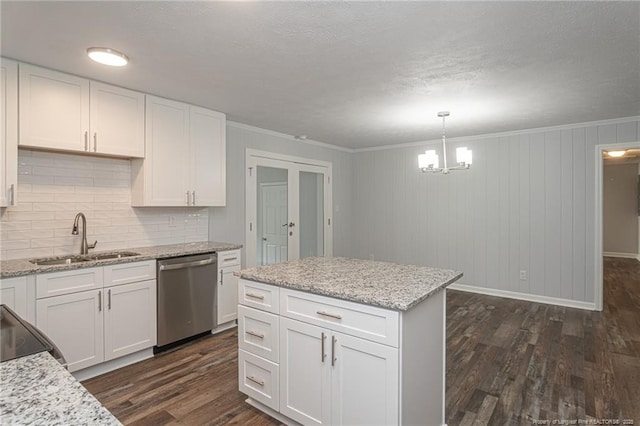 2110 Lombardy Dr, Fayetteville, NC 28304 - kitchen featuring stainless steel dishwasher, dark wood-type flooring, a chandelier, backsplash, and white cabinetry