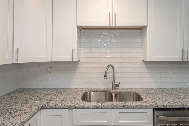 2110 Lombardy Dr, Fayetteville, NC 28304 - kitchen with white cabinets, backsplash, stainless steel dishwasher, and light stone counters