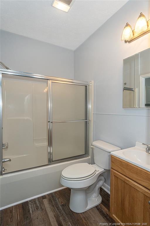 2110 Lombardy Dr, Fayetteville, NC 28304 - bathroom featuring wood finished floors, vanity, and shower / bath combination with glass door