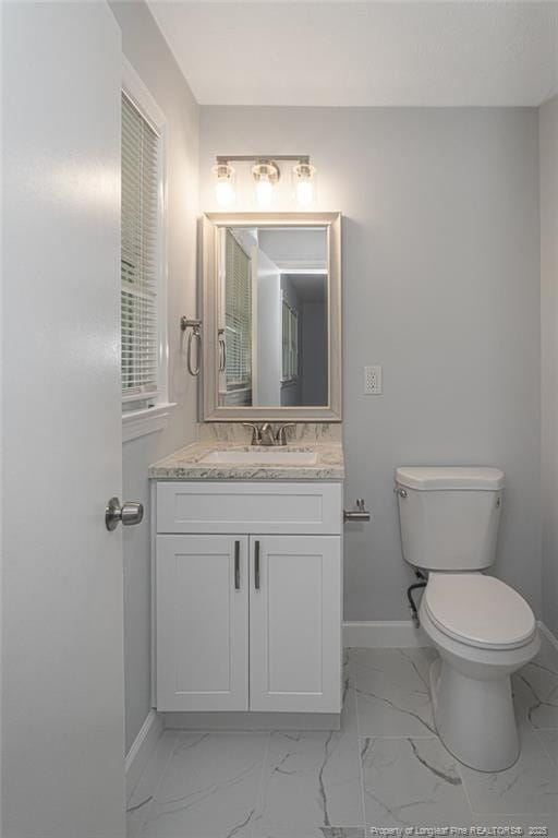 2110 Lombardy Dr, Fayetteville, NC 28304 - bathroom featuring marble look tiles and vanity