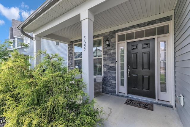 525 Willow Breeze Ct, Zebulon, NC 27597 - view of exterior entry featuring stone siding and a porch