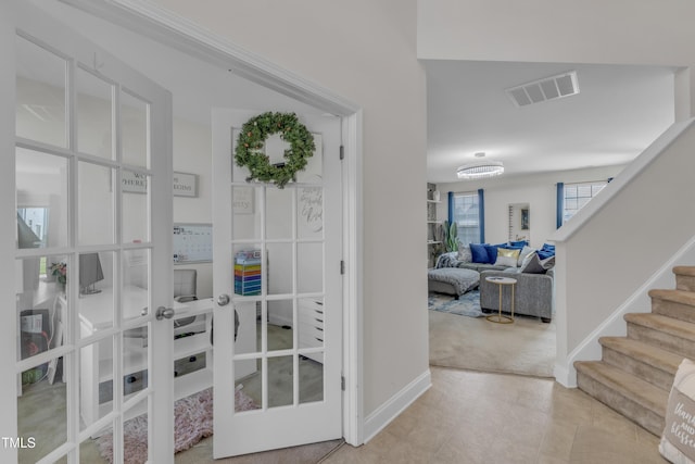 525 Willow Breeze Ct, Zebulon, NC 27597 - foyer entrance featuring light carpet, french doors, stairs, and light tile patterned floors