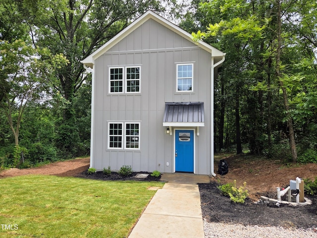 608 E Umstead St, Durham, NC 27701 - view of front of home featuring board and batten siding and a front yard
