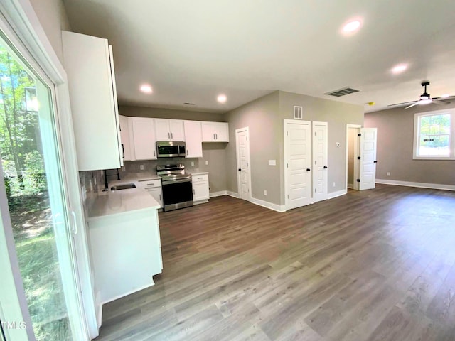 608 E Umstead St, Durham, NC 27701 - kitchen featuring appliances with stainless steel finishes, open floor plan, light countertops, white cabinetry, and a ceiling fan