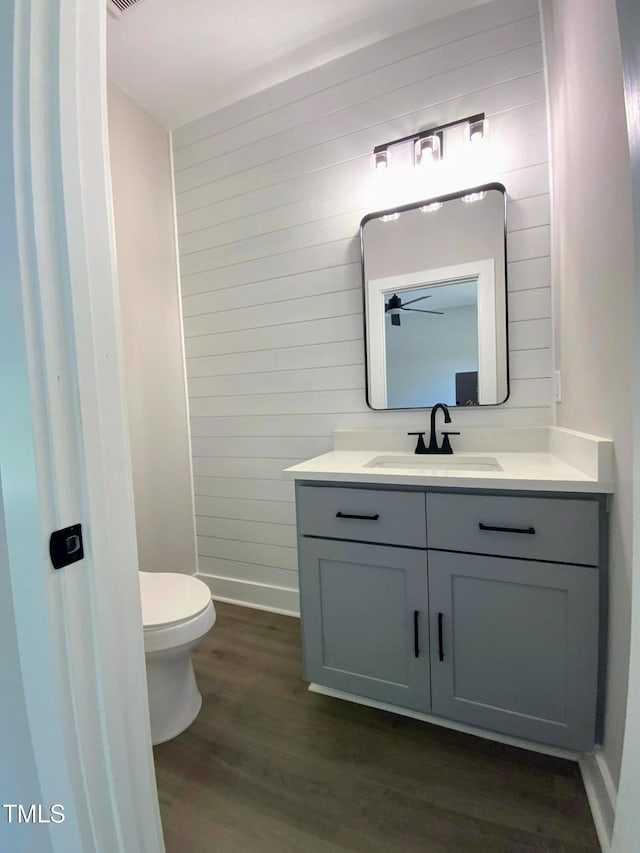 608 E Umstead St, Durham, NC 27701 - half bathroom featuring vanity, wood finished floors, and wooden walls