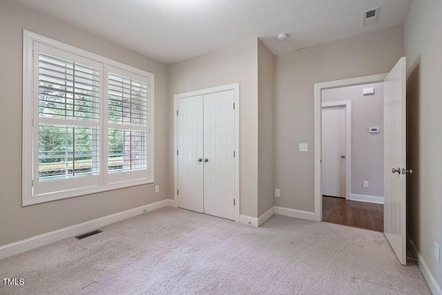 1962 Briar Chapel Pkwy, Chapel Hill, NC 27516 - unfurnished bedroom featuring carpet floors, multiple windows, and a closet