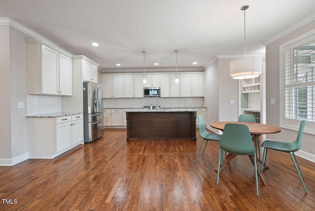 1962 Briar Chapel Pkwy, Chapel Hill, NC 27516 - kitchen with appliances with stainless steel finishes, tasteful backsplash, white cabinetry, dark wood-style flooring, and crown molding