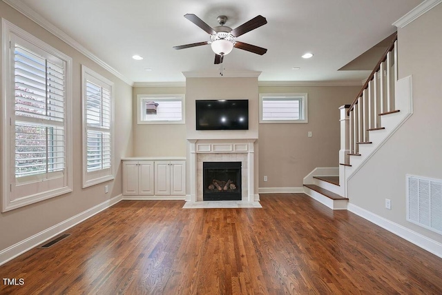 1962 Briar Chapel Pkwy, Chapel Hill, NC 27516 - unfurnished living room featuring wood finished floors, ceiling fan, a fireplace, crown molding, and stairway