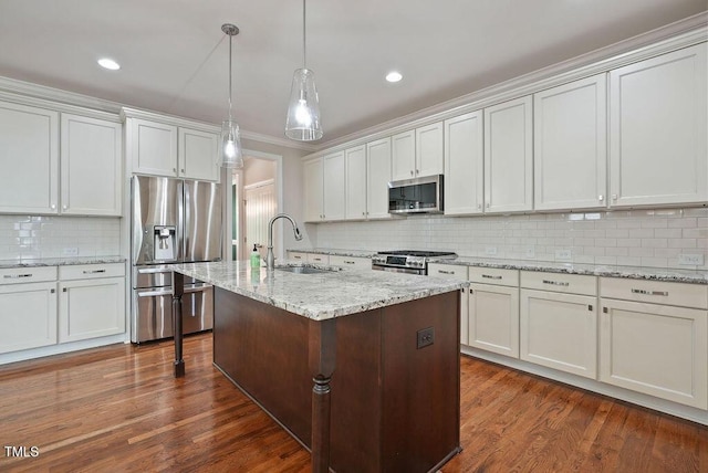 1962 Briar Chapel Pkwy, Chapel Hill, NC 27516 - kitchen featuring stainless steel appliances, backsplash, dark wood-style flooring, pendant lighting, and an island with sink