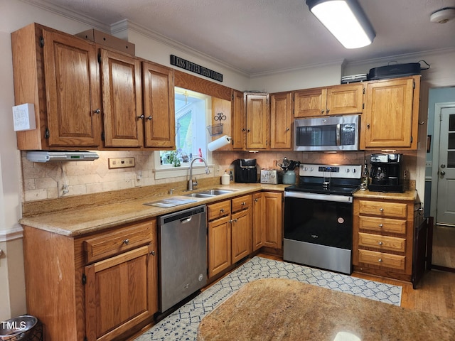 5760 Hesters Store Rd, Hurdle Mills, NC 27541 - kitchen with appliances with stainless steel finishes, ornamental molding, light countertops, backsplash, and brown cabinetry