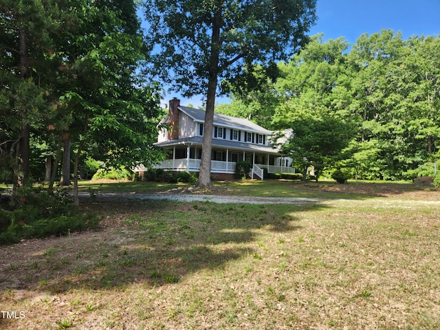 5760 Hesters Store Rd, Hurdle Mills, NC 27541 - view of front of house featuring a porch, a chimney, and a front lawn
