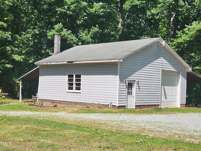 5760 Hesters Store Rd, Hurdle Mills, NC 27541 - view of property exterior with a chimney, a lawn, a garage, and an outbuilding