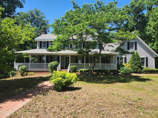 5760 Hesters Store Rd, Hurdle Mills, NC 27541 - view of front facade with covered porch, a chimney, and a front yard