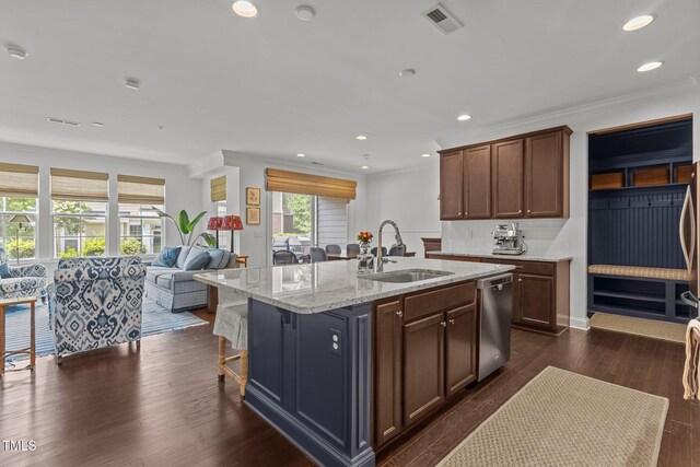 9302 Nellman Ln, Raleigh, NC 27617 - kitchen featuring stainless steel dishwasher, open floor plan, an island with sink, light stone counters, and dark wood-style flooring