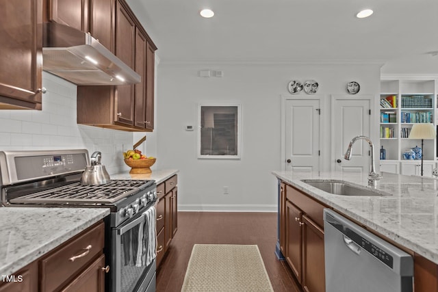 9302 Nellman Ln, Raleigh, NC 27617 - kitchen with appliances with stainless steel finishes, under cabinet range hood, crown molding, dark wood-style floors, and backsplash
