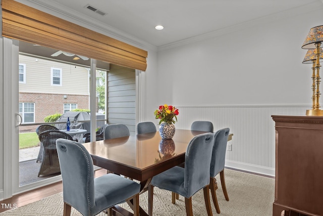 9302 Nellman Ln, Raleigh, NC 27617 - dining room featuring ornamental molding, wood finished floors, and wainscoting