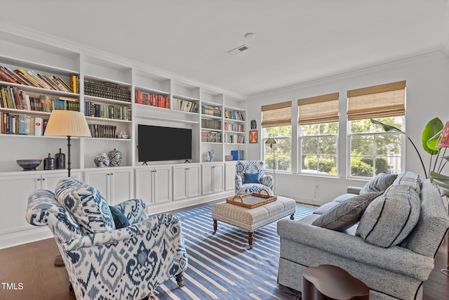 9302 Nellman Ln, Raleigh, NC 27617 - living room featuring crown molding, wood finished floors, and built in features