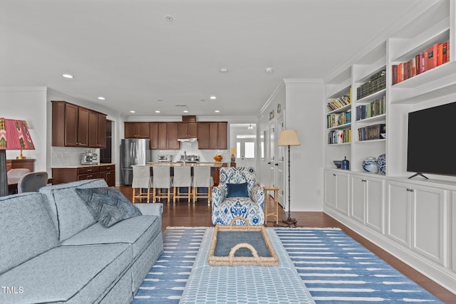 9302 Nellman Ln, Raleigh, NC 27617 - living area with ornamental molding, recessed lighting, dark wood-style flooring, and built in shelves