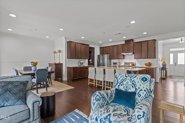 9302 Nellman Ln, Raleigh, NC 27617 - living area featuring crown molding, dark wood-style flooring, wainscoting, and recessed lighting