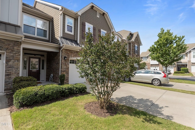9302 Nellman Ln, Raleigh, NC 27617 - townhome / multi-family property with stone siding, a garage, and concrete driveway