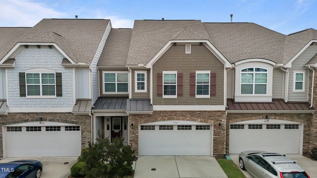 9302 Nellman Ln, Raleigh, NC 27617 - multi unit property with a shingled roof, stone siding, concrete driveway, and a garage
