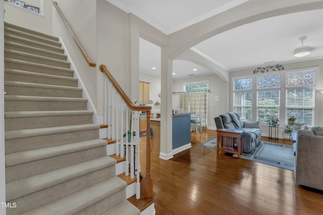 12227 Orchardgrass Ln, Raleigh, NC 27614 - entrance foyer featuring arched walkways, wood finished floors, stairway, crown molding, and recessed lighting