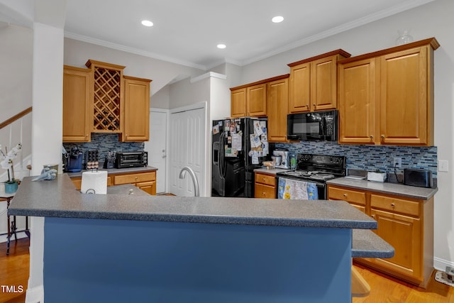 12227 Orchardgrass Ln, Raleigh, NC 27614 - kitchen featuring black appliances, decorative backsplash, light wood-type flooring, a peninsula, and recessed lighting