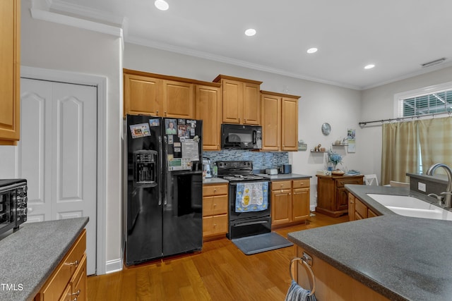 12227 Orchardgrass Ln, Raleigh, NC 27614 - kitchen featuring black appliances, light wood-style flooring, backsplash, recessed lighting, and dark countertops