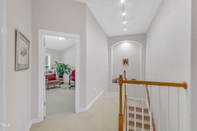 12227 Orchardgrass Ln, Raleigh, NC 27614 - hallway featuring an upstairs landing, light colored carpet, arched walkways, and rail lighting