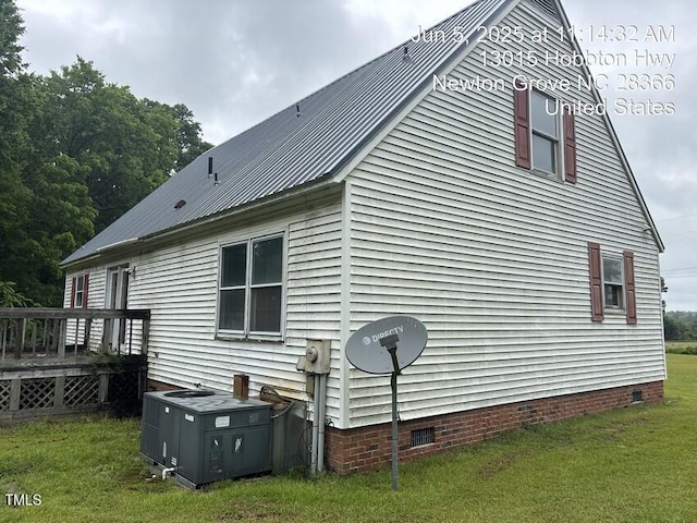 13015 Hobbton Hwy, Newton Grove, NC 28366 - view of side of home with crawl space, a deck, a lawn, and a metal roof