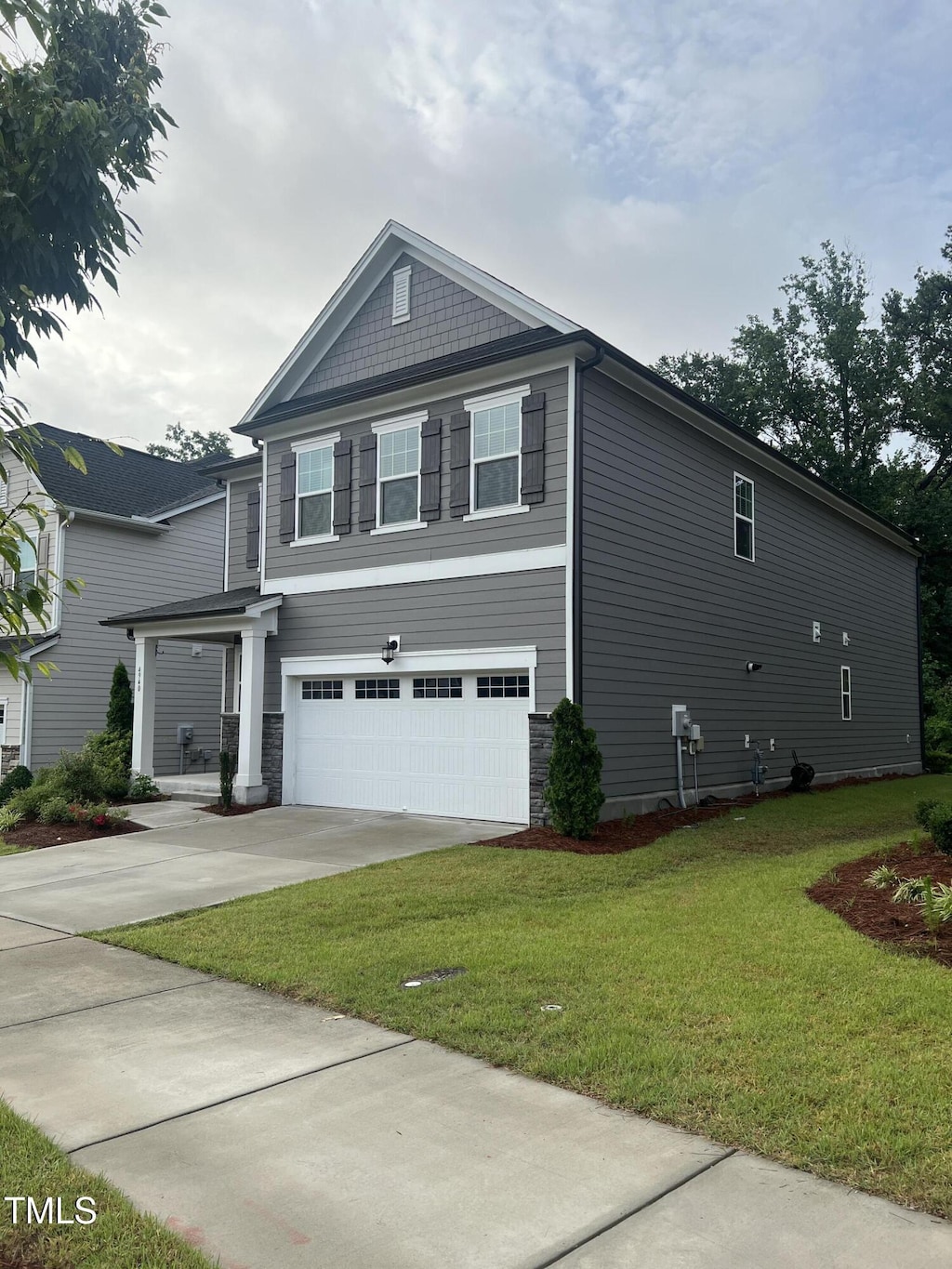 4940 Enlightenment Rd, Raleigh, NC 27616 - view of property exterior with a garage, driveway, and a lawn