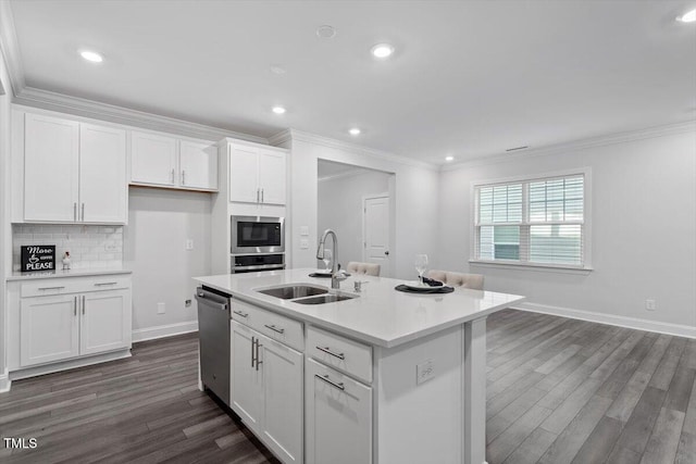 4940 Enlightenment Rd, Raleigh, NC 27616 - kitchen featuring appliances with stainless steel finishes, dark wood finished floors, white cabinets, ornamental molding, and light countertops