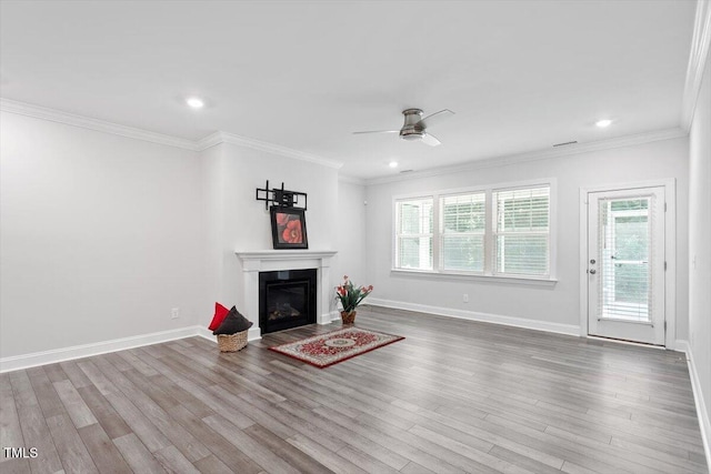4940 Enlightenment Rd, Raleigh, NC 27616 - unfurnished living room featuring ceiling fan, plenty of natural light, wood finished floors, a glass covered fireplace, and recessed lighting