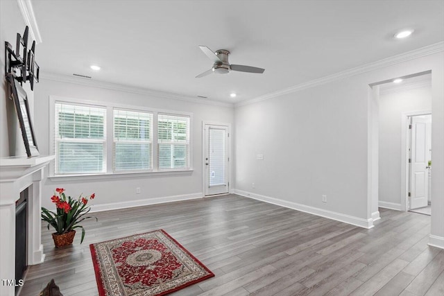 4940 Enlightenment Rd, Raleigh, NC 27616 - unfurnished living room with ceiling fan, wood finished floors, recessed lighting, and crown molding