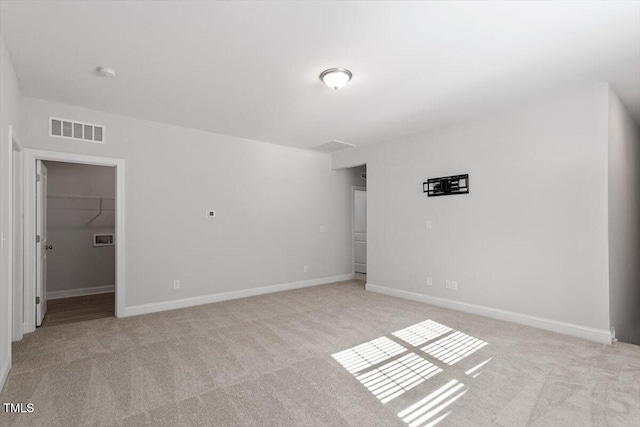 4940 Enlightenment Rd, Raleigh, NC 27616 - empty room featuring light carpet and a smoke detector